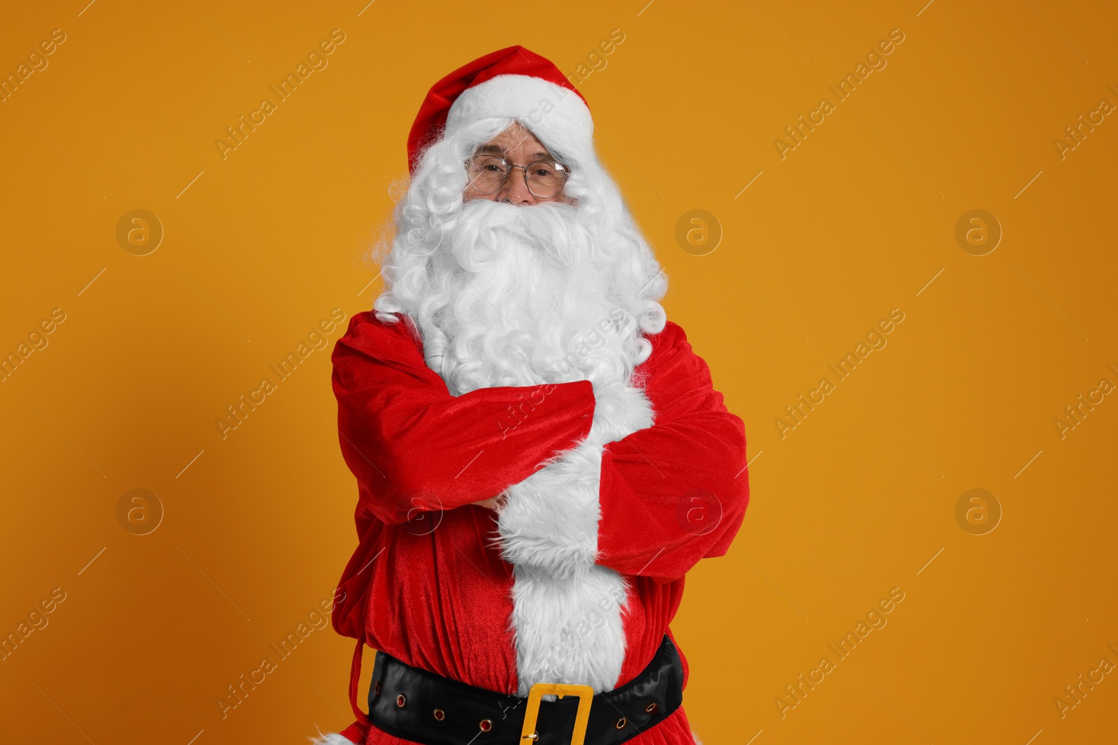 Photo of Merry Christmas. Santa Claus on orange background