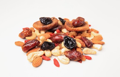 Pile of mixed dried fruits and nuts on white background, closeup