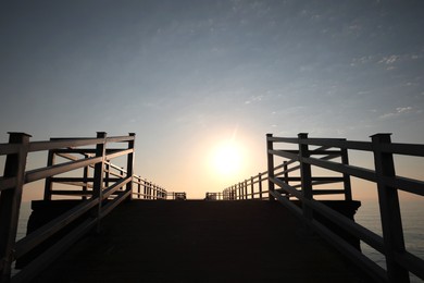 Photo of Empty pier at sunrise, low angle view