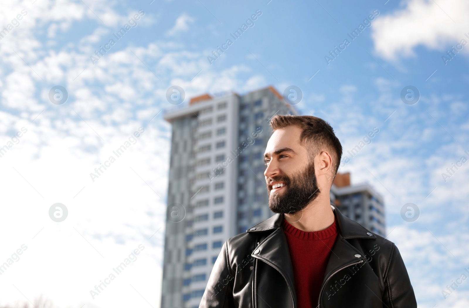 Photo of Portrait of stylish young man on city street