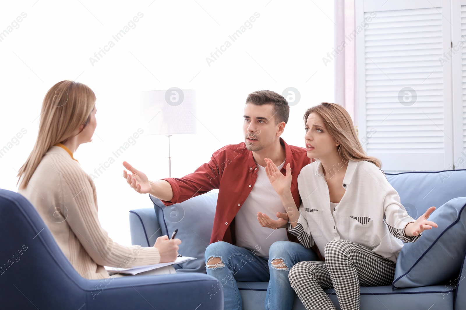 Photo of Young couple with problem at family psychologist office