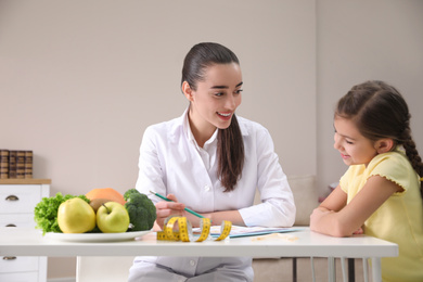 Little girl visiting professional nutritionist in office