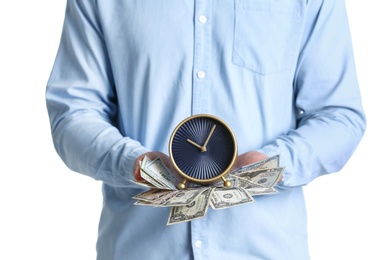 Photo of Young man holding alarm clock and cash on white background. Time is money concept