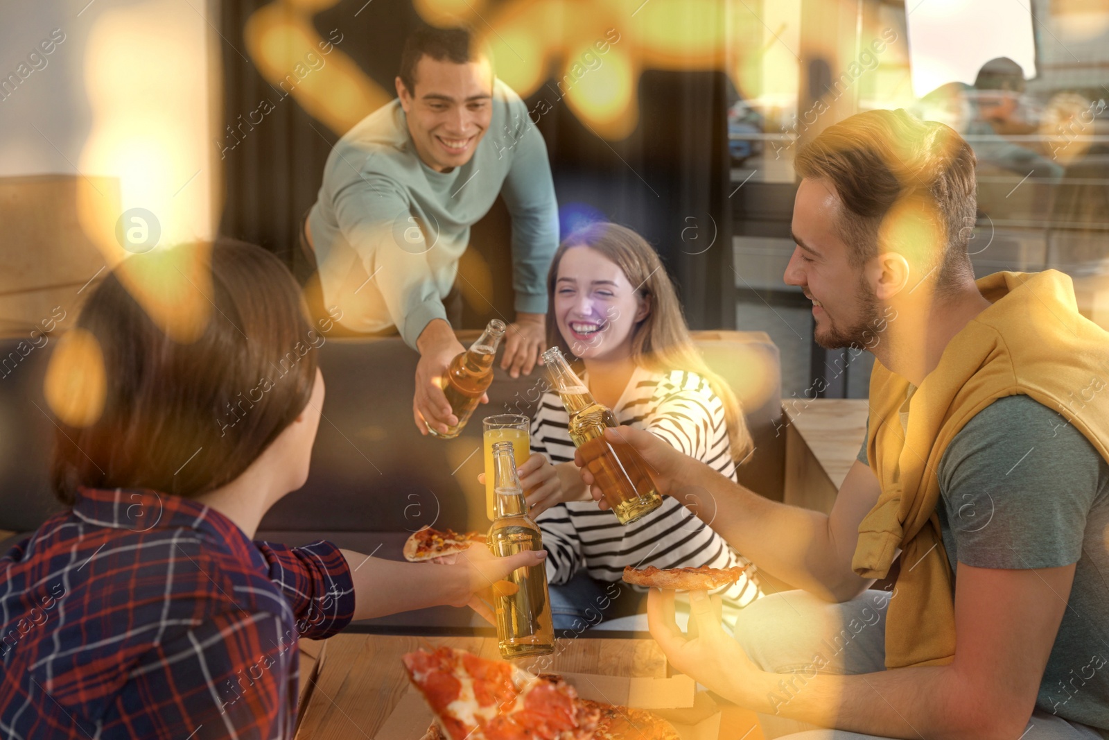 Image of Group of friends having fun party with delicious pizza in cafe, bokeh effect