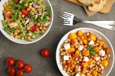 Photo of Delicious fresh chickpea salads on grey table, flat lay