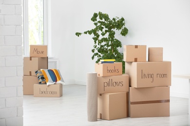 Photo of Cardboard boxes and household stuff indoors. Moving day