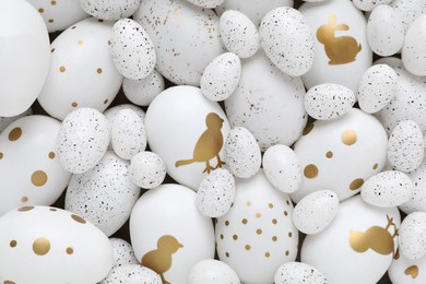 Photo of Many painted Easter eggs as background, top view