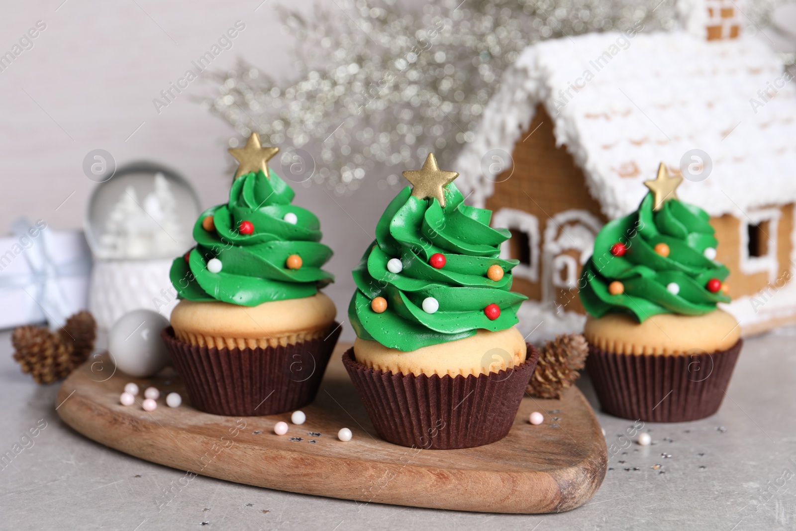 Photo of Christmas tree shaped cupcakes on light grey table