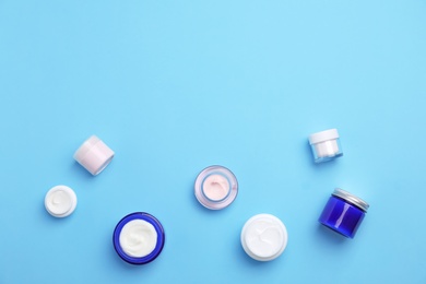 Photo of Flat lay composition with cosmetic products on color background