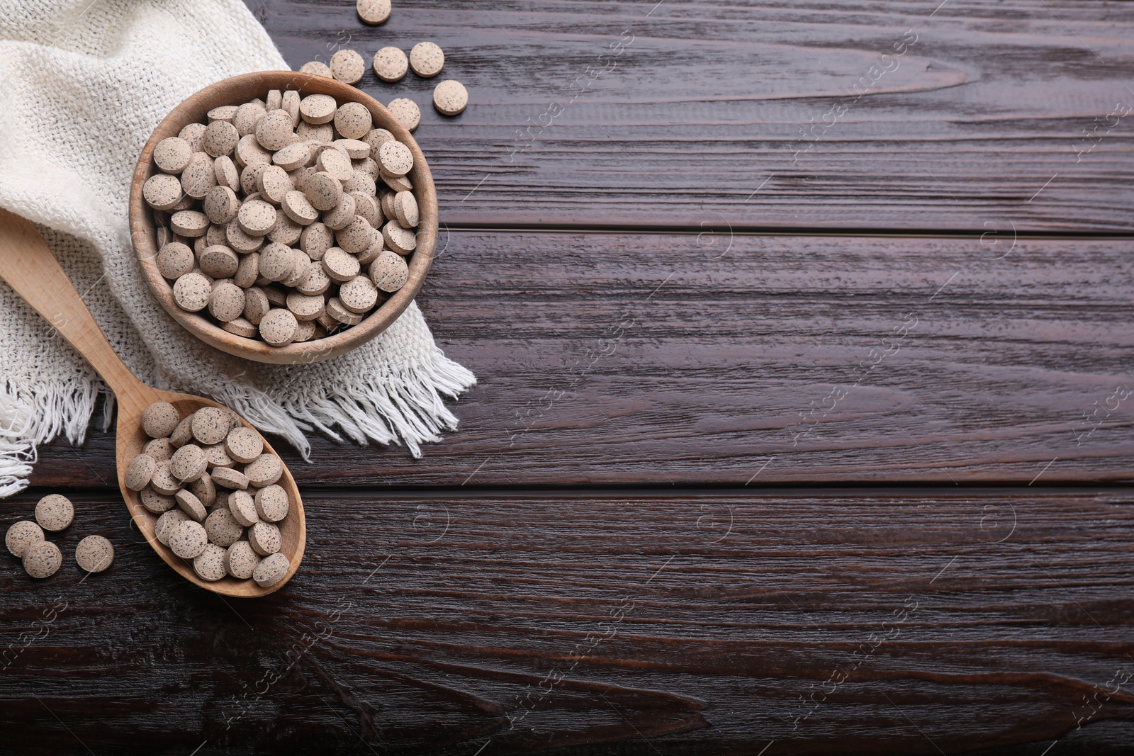 Photo of Flat lay composition with brewer`s yeast tablets on wooden table. Space for text