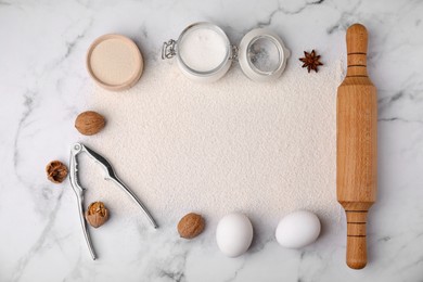 Photo of Frame made of flour and ingredients on white marble table, flat lay. Space for text
