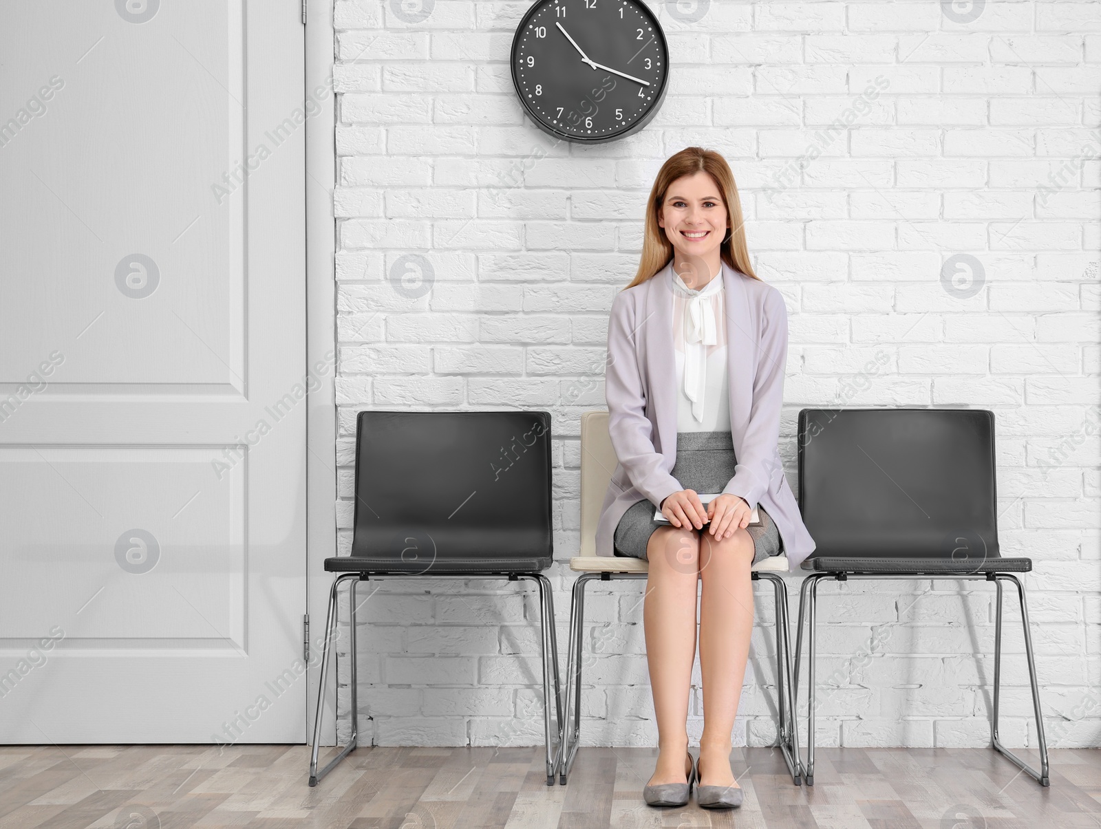 Photo of Young woman waiting for job interview, indoors