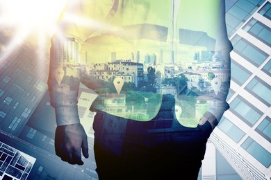 Image of Engineer with hard hat and cityscapes, multiple exposure