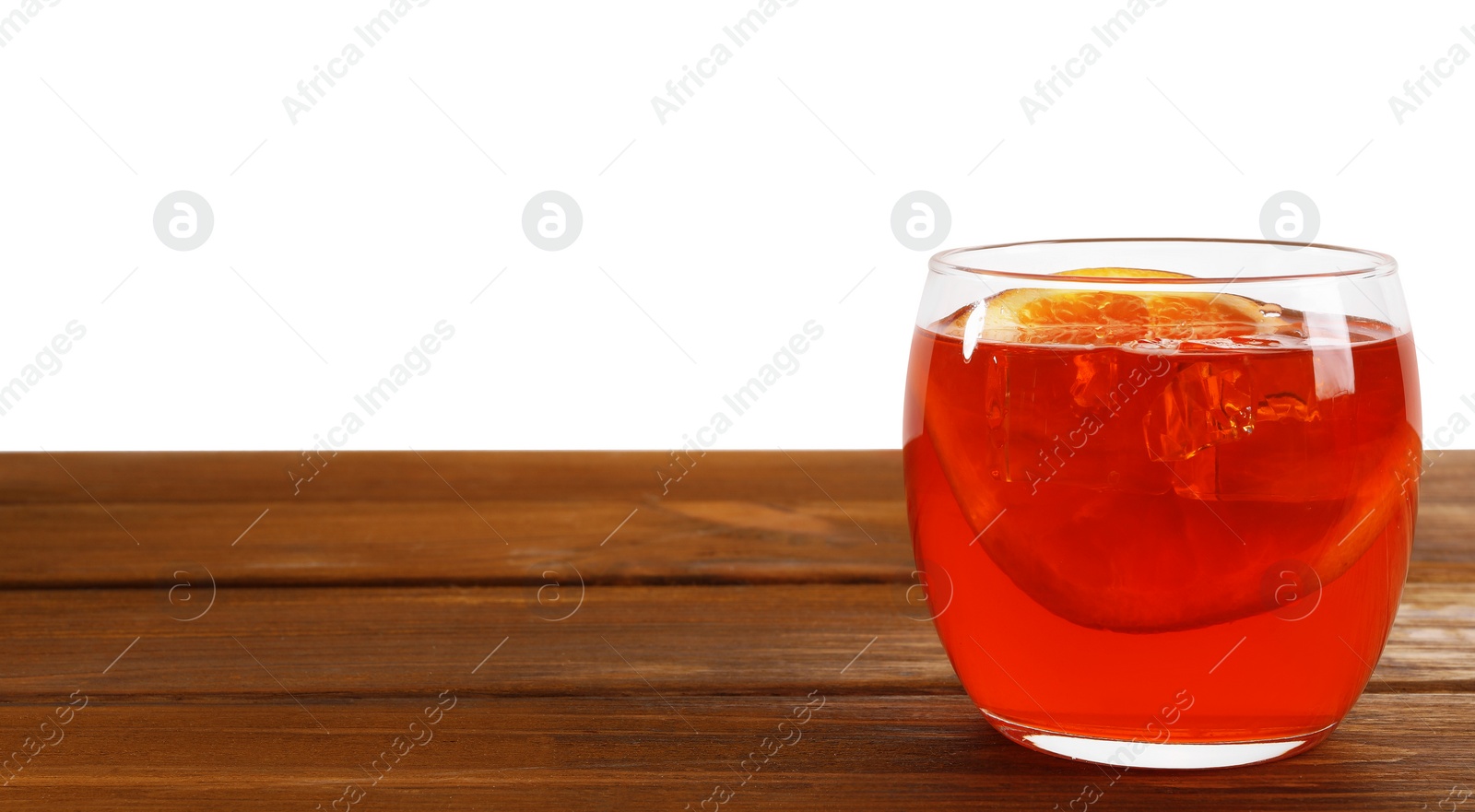 Photo of Aperol spritz cocktail and orange slices in glass on wooden table against white background