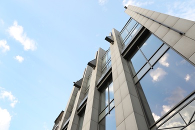 Photo of Modern office building with tinted windows on sunny day