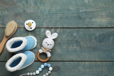 Photo of Cute baby stuff on light blue wooden background, flat lay. Space for text