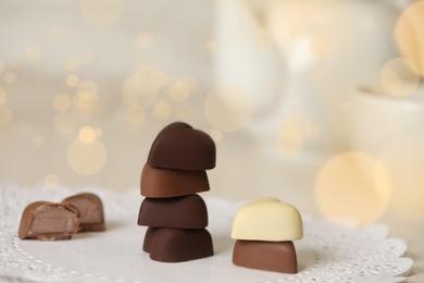 Delicious heart shaped chocolate candies on table