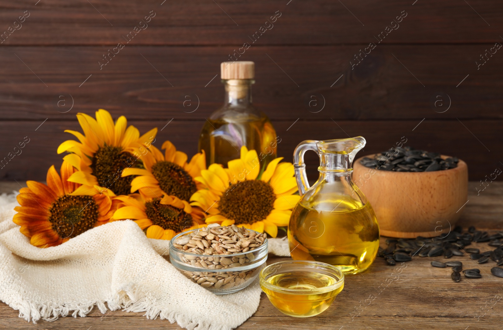 Photo of Composition with sunflower oil on wooden table