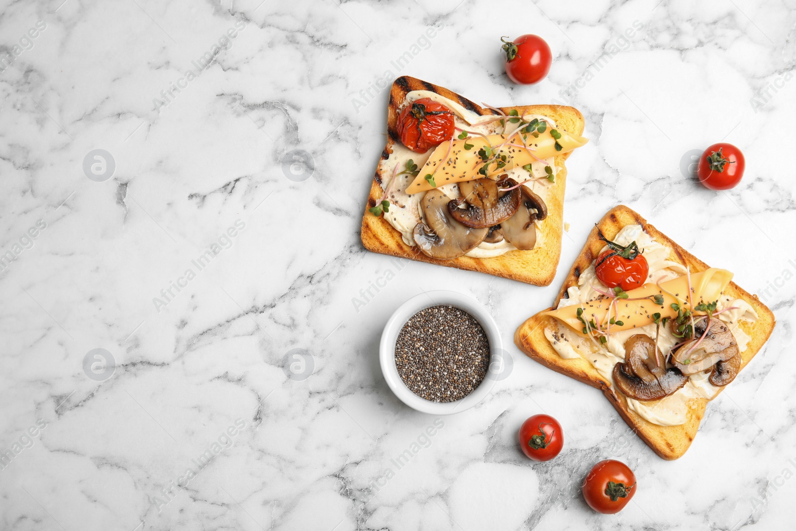 Photo of Flat lay composition with tasty toasts, cherry tomatoes and chia seeds on marble background. Space for text