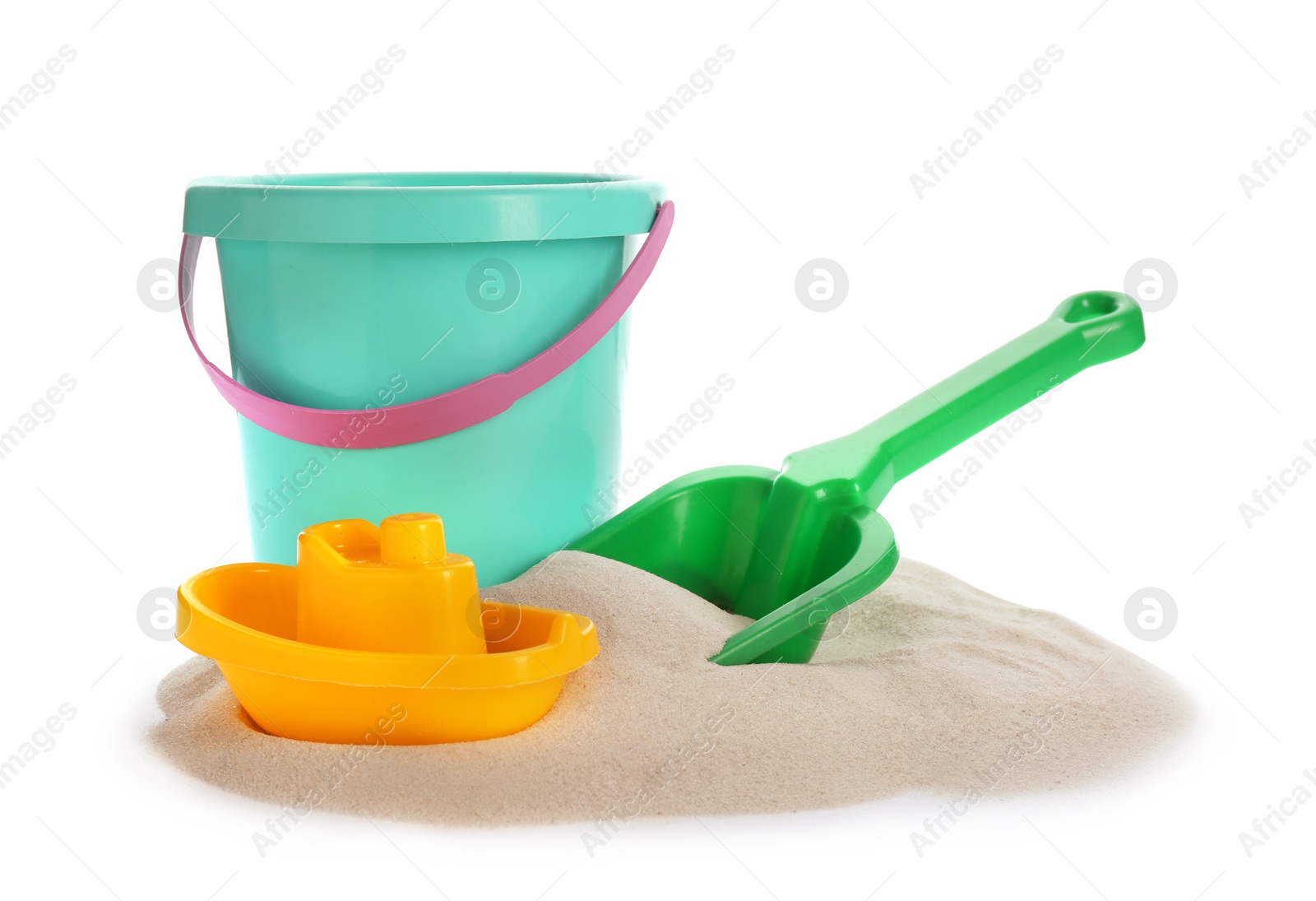 Photo of Plastic beach toys on pile of sand against white background