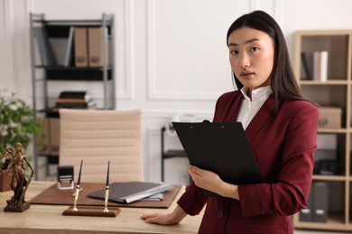 Portrait of notary with clipboard in office. Space for text