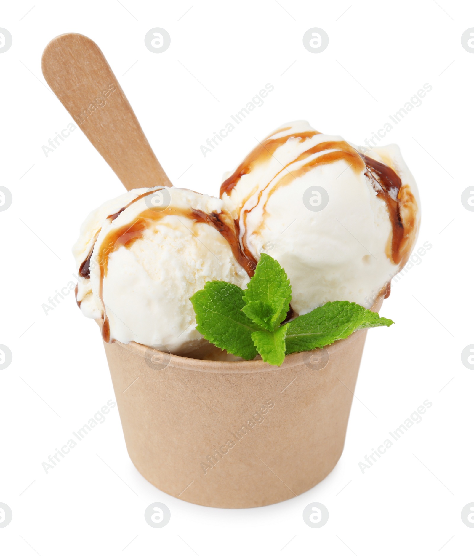Photo of Scoops of delicious ice cream with caramel sauce and mint in paper cup isolated on white