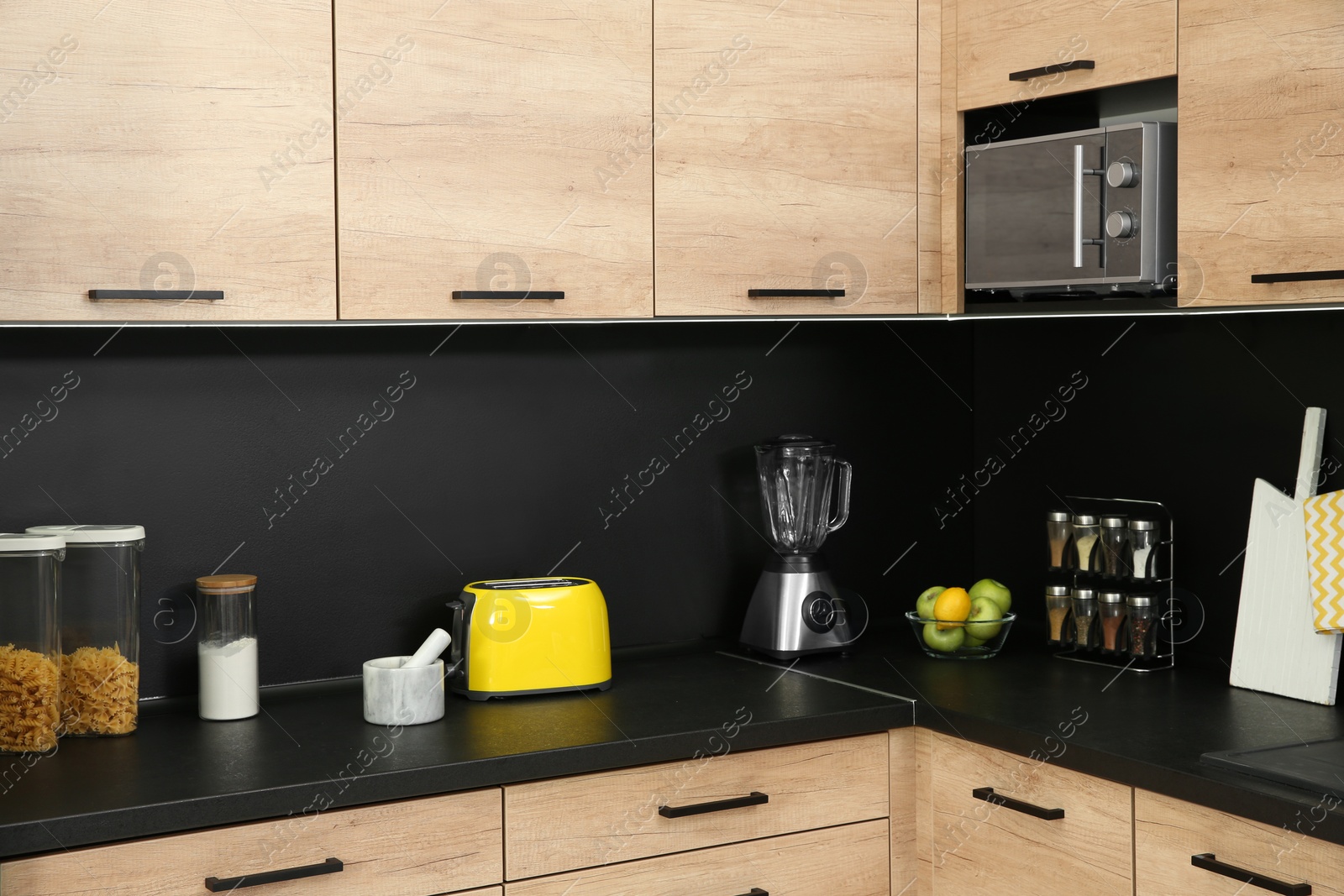 Photo of Kitchen interior with new furniture, appliances and houseware