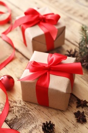 Photo of Christmas gift box and decor on wooden table, closeup