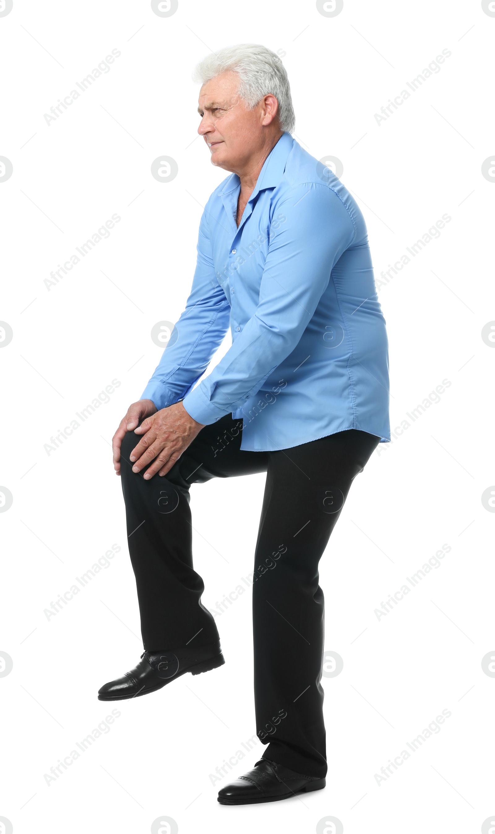 Photo of Full length portrait of senior man having knee problems on white background