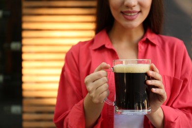 Photo of Young woman with cold kvass outdoors, closeup. Traditional Russian summer drink