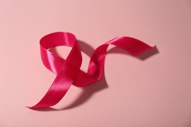 Photo of Pink ribbon on color background. Breast cancer awareness concept