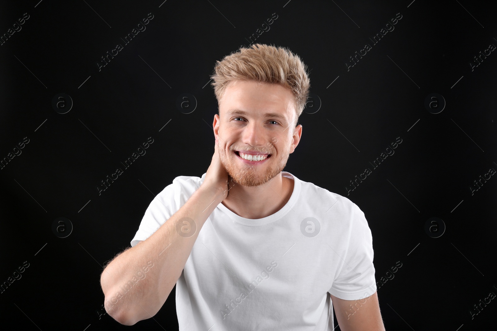 Photo of Portrait of handsome young man on black background