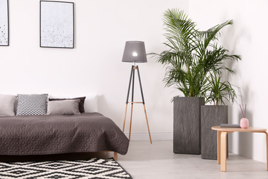 Beautiful interior of bedroom with potted plants