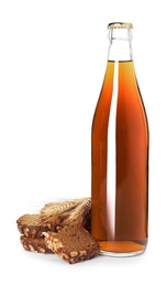 Photo of Glass bottle of delicious kvass, spikelets and bread slices on white background. Refreshing drink