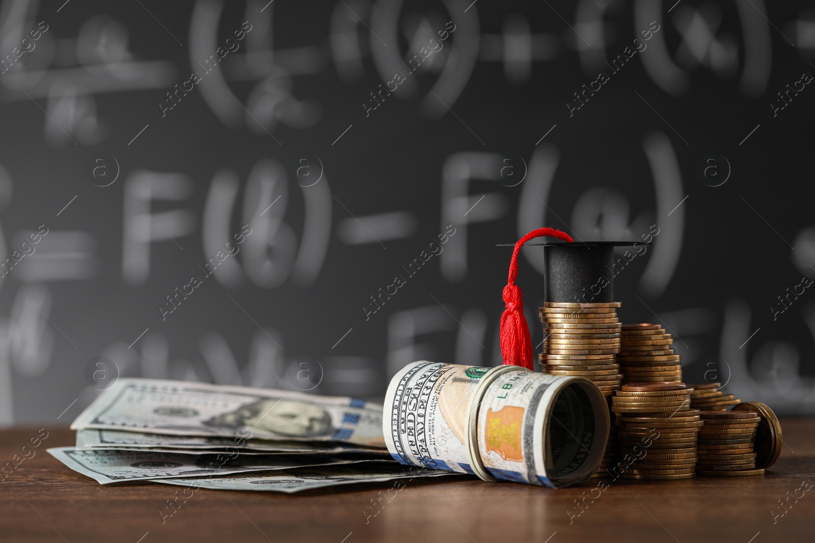 Photo of Scholarship concept. Coins, dollar banknotes and graduation cap on wooden table