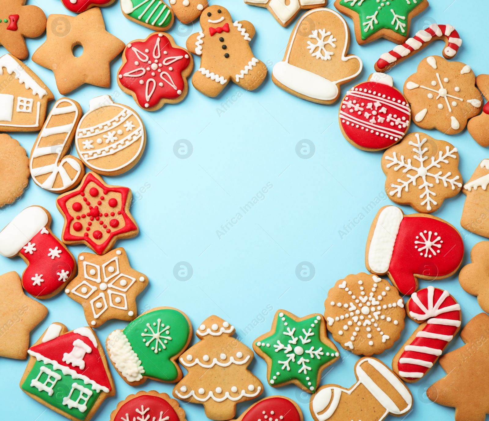 Photo of Flat lay composition with tasty homemade Christmas cookies on light blue background, space for text