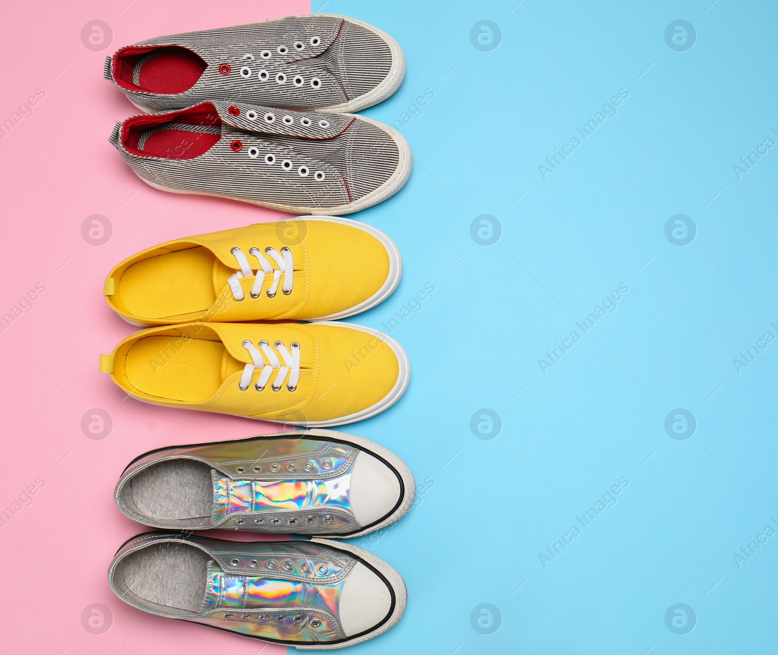 Photo of Modern trendy sneakers on color background, top view. Space for text