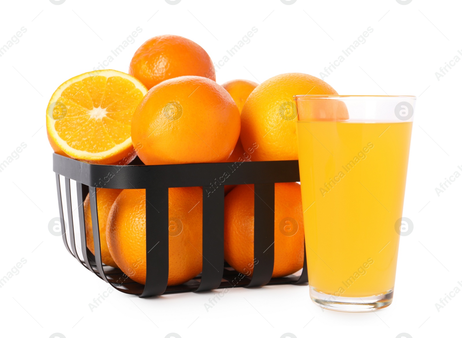 Photo of Fresh oranges in metal basket and glass of juice isolated on white