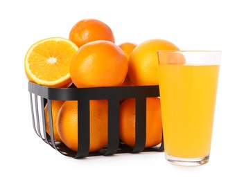 Fresh oranges in metal basket and glass of juice isolated on white