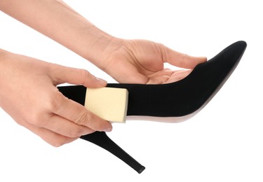 Photo of Woman cleaning suede leather shoe on white background, closeup. Footwear care accessory