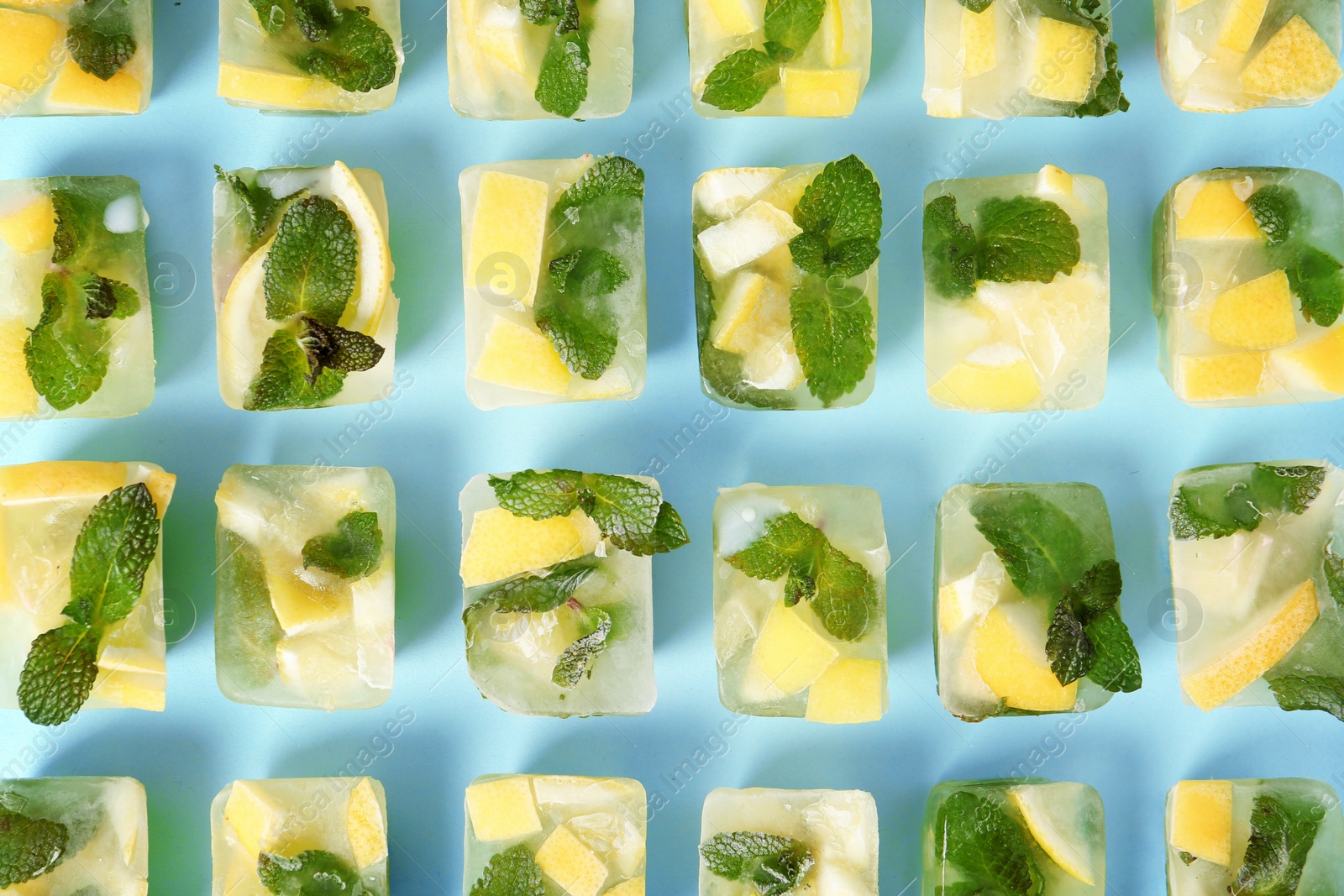 Photo of Flat lay composition with lemon and mint ice cubes on color background