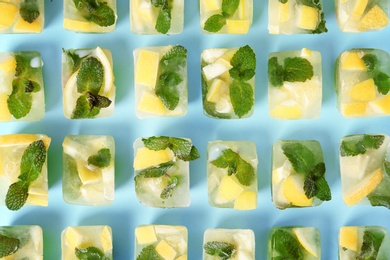 Photo of Flat lay composition with lemon and mint ice cubes on color background