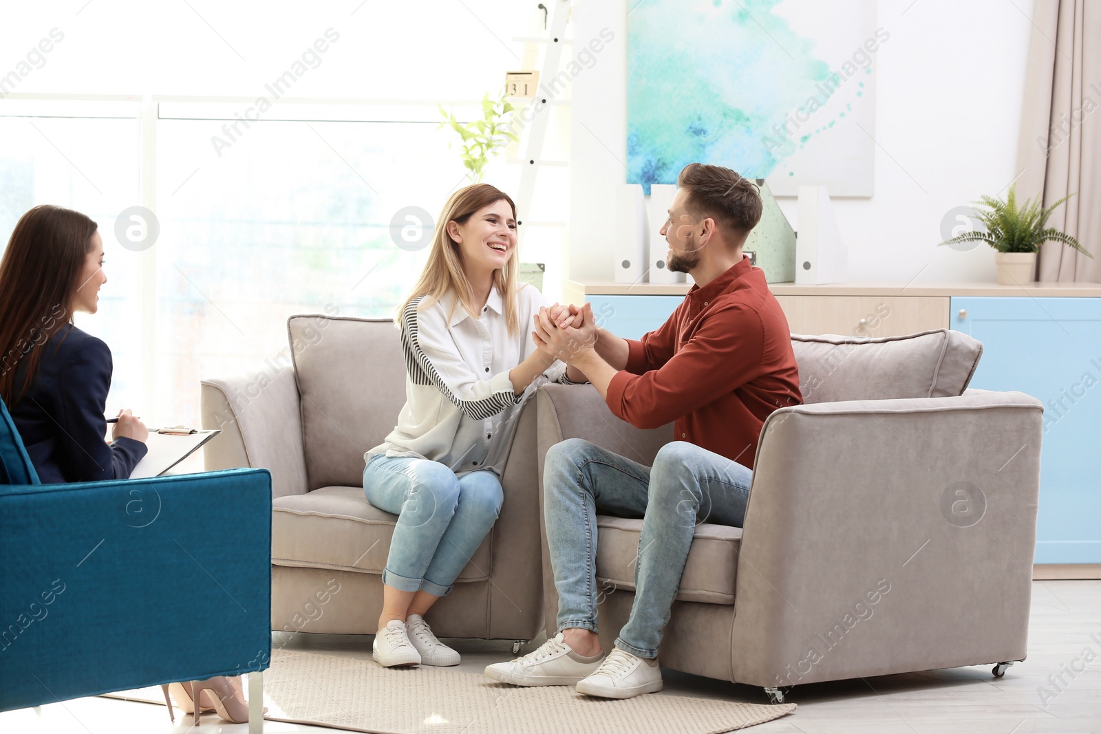 Photo of Family psychologist working with young couple in office