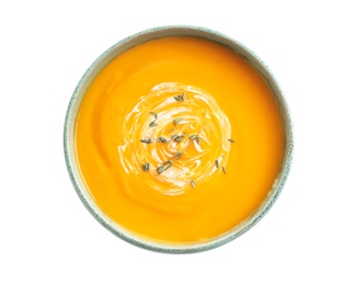 Delicious pumpkin cream soup in bowl on white background, top view