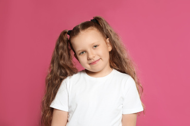 Photo of Portrait of little girl on pink background