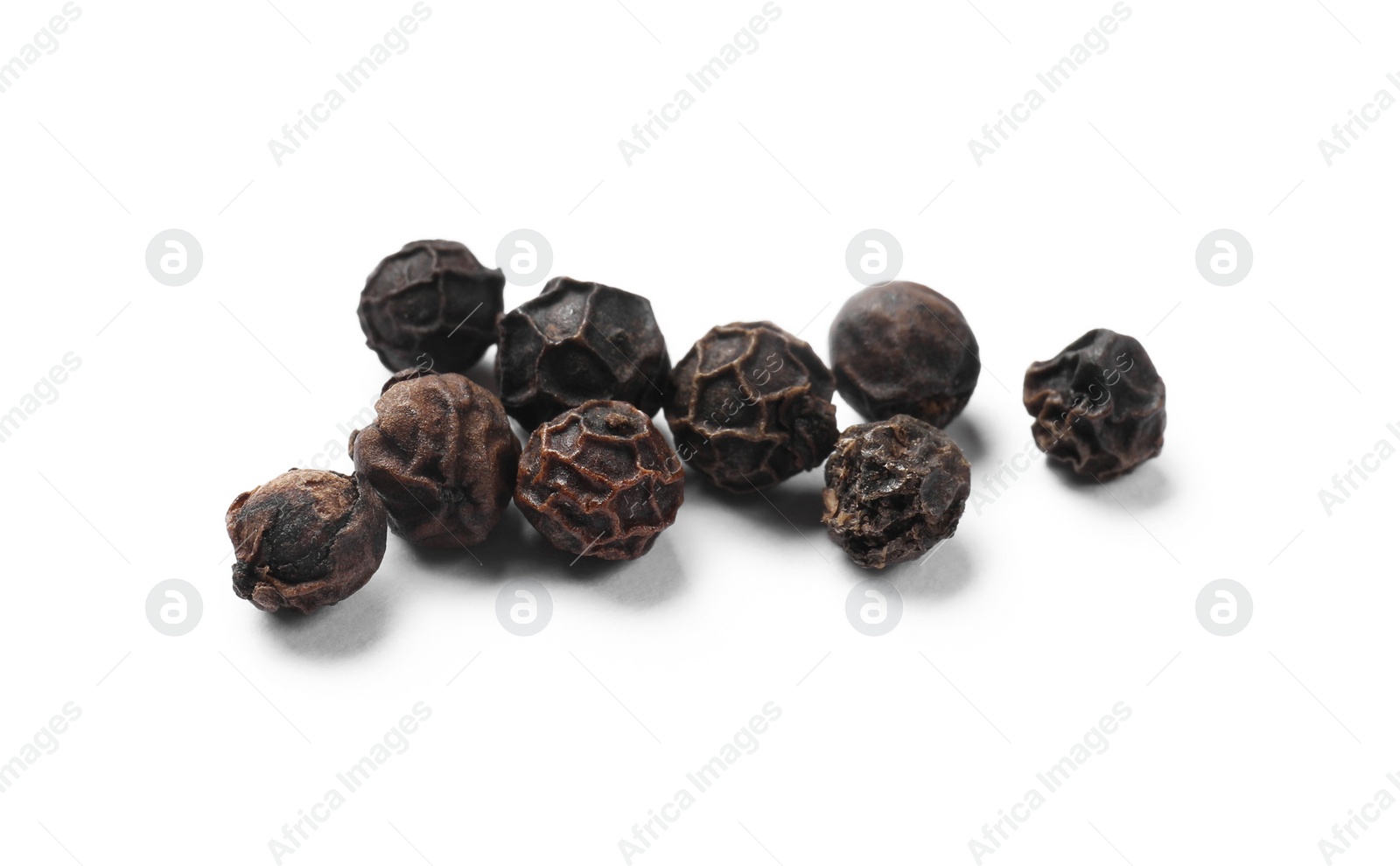 Photo of Aromatic spice. Many black dry peppercorns isolated on white