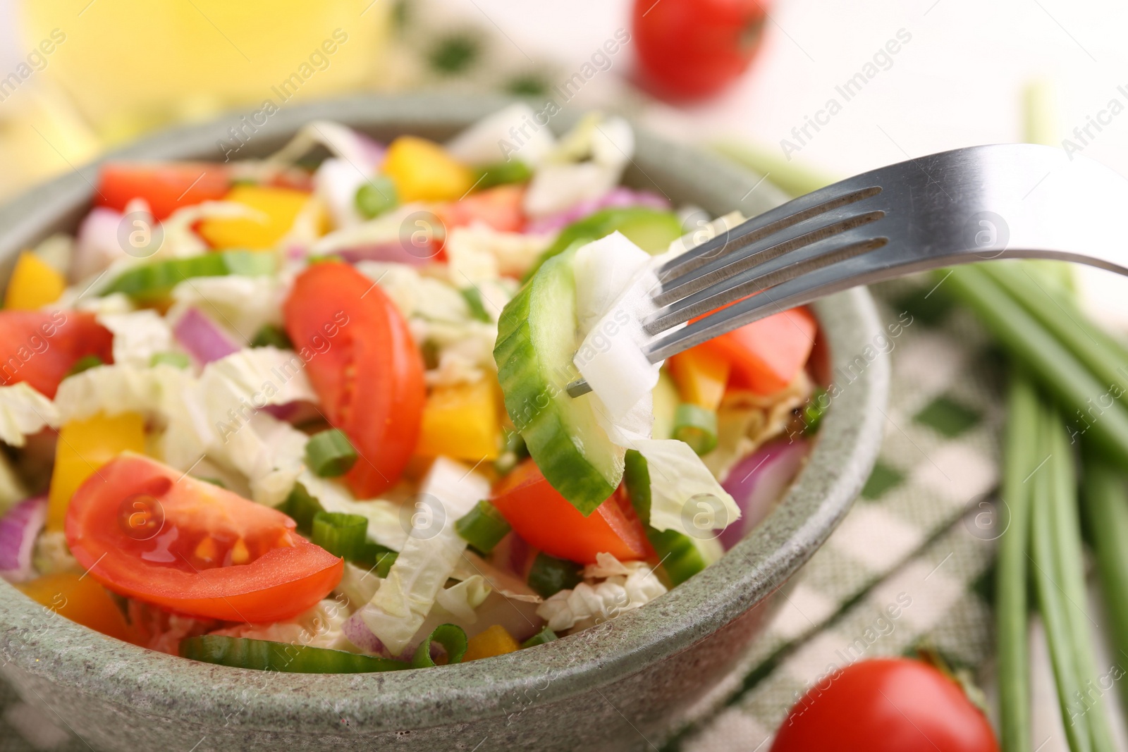 Photo of Eating delicious salad with Chinese cabbage at table, closeup