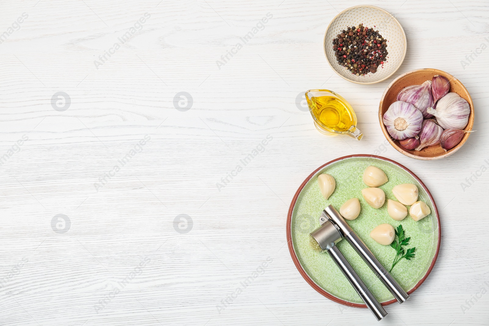 Photo of Flat lay composition with garlic press on wooden table