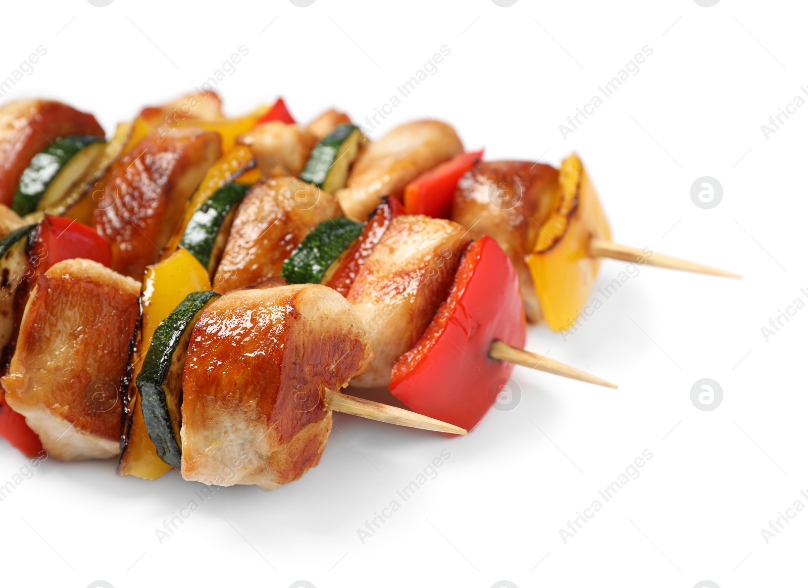 Photo of Delicious chicken shish kebabs with vegetables on white background, closeup