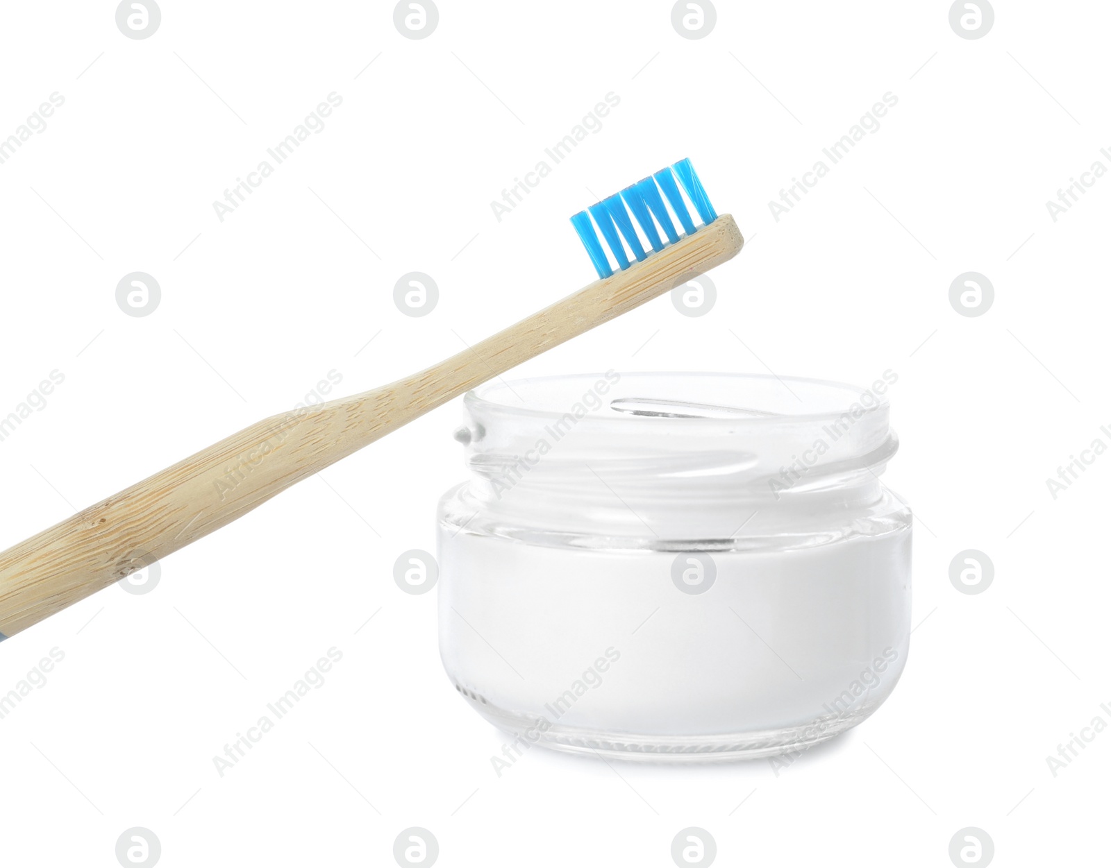 Photo of Bamboo toothbrush and bowl with baking soda on white background